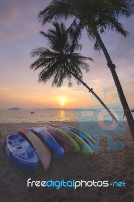 Sunrise With Kayak Boat And Coconut Palm Trees On Tropical Beach… Stock Photo