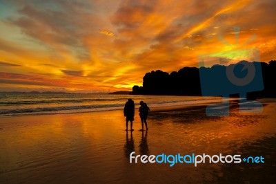 Sunset Couple On The Beach Stock Photo