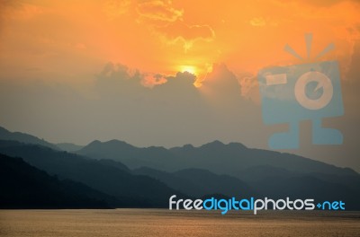 Sunset Over A Mountain At Lake Stock Photo