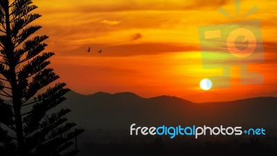 Sunset Over Mountain Range Stock Photo