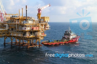  Supply Boat Transfer Cargo To Oil And Gas Industry And Moving Cargo From The Boat To The Platform Stock Photo