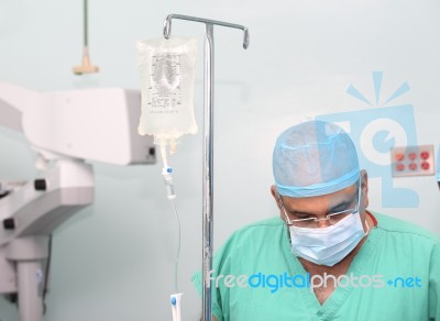 Surgeon Testing The Infusion To A Patient Stock Photo