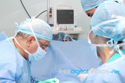 Surgeons Team Working In The Operation Room Stock Photo
