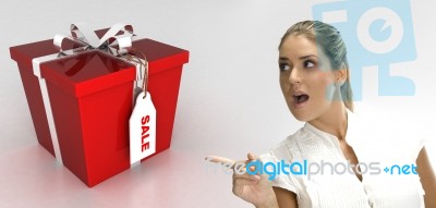 Surprised Blonde Woman Pointing To Gift Stock Photo
