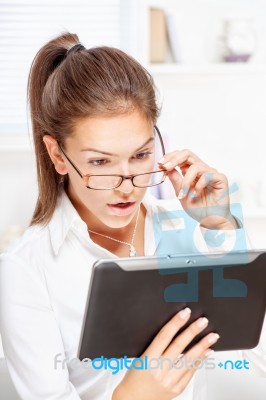 Surprised Businesswoman Looking At Tablet Computer Stock Photo