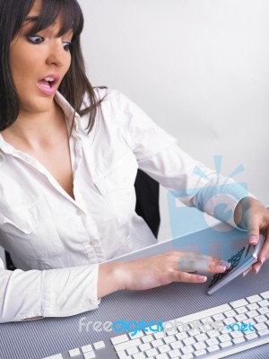 Surprised Woman Using Calculator Stock Photo