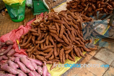 Sweet Potato Stack On Ground For Sale At The Market Stock Photo