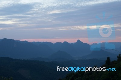 Sweet Sky With Big Mountains Background Stock Photo