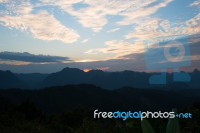 Sweet Sunset Sky With Big Mountains Background Stock Photo
