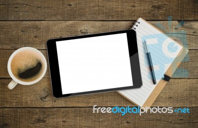 Tablet On Wood Desk On Top View Stock Photo