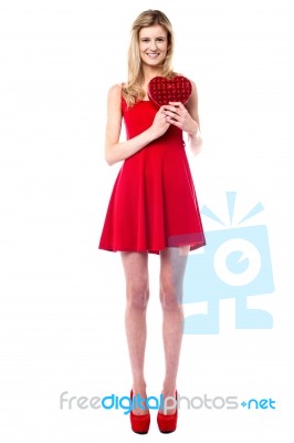 Tall Sexy Girl Holding Heart Shaped Gift Stock Photo