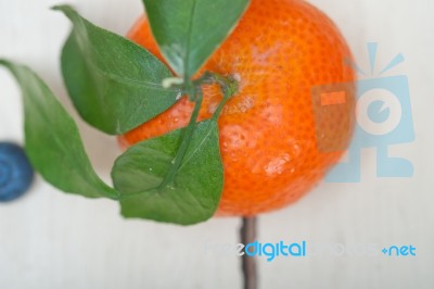 Tangerine And Blueberry On White Table Stock Photo