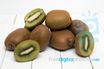 Tasty Kiwi Fruits Isolated On A White Wooden Background Stock Photo