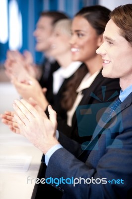 Team Of Four Corporates Applauding Stock Photo