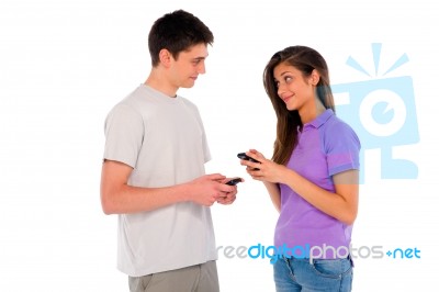 Teenage Couple Holding Smartphone Stock Photo