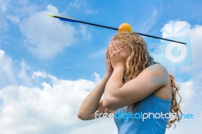 Teenage Girl Feeling Fear With Apple And Arrow On Head Stock Photo