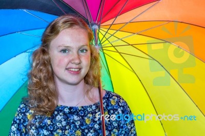 Teenage Girl Under Colorful Umbrella Stock Photo