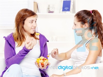 Teenage Girls Chating And Eating Fruit Stock Photo