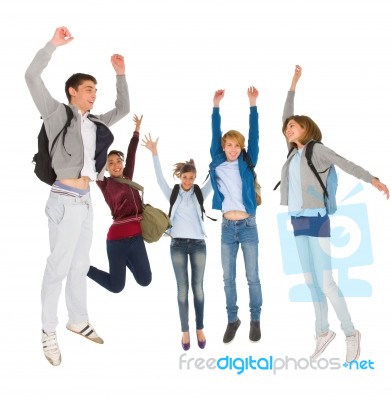 Teenage Students Jumping Stock Photo