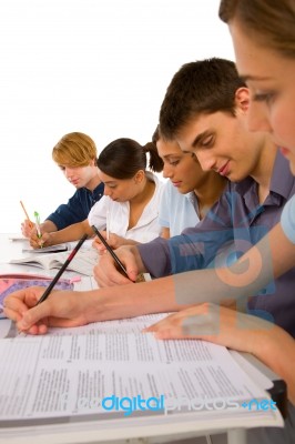 Teenage students Writing On book Stock Photo