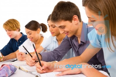 Teenage students Writing On book Stock Photo