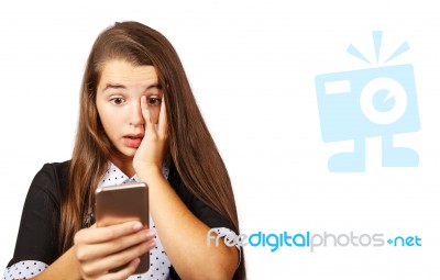 Teenager Girl Looks At Smartphone Display In Surprise Stock Photo