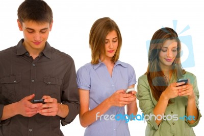 Teenagers Reading Sms Stock Photo