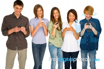 Teenagers Reading Sms Stock Photo