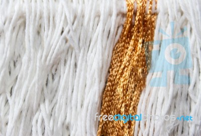 Texture Of Wool Fringe And White And Gold Threads Stock Photo