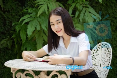 Thai Adult Student University Beautiful Girl Reading Red Book Stock Photo