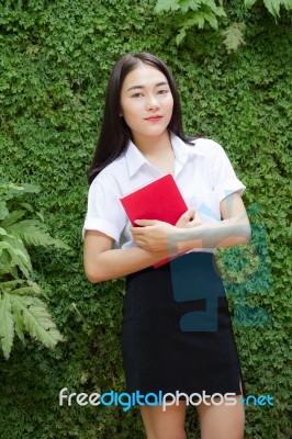Thai Adult Student University Beautiful Girl Reading Red Book Stock Photo