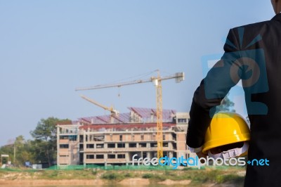 The Arms Of A Male Businessman Holding A Helmet Stock Photo