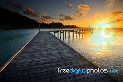 The Beautiful Wooden Pier With Sunrise At Rayong, Thailand Stock Photo