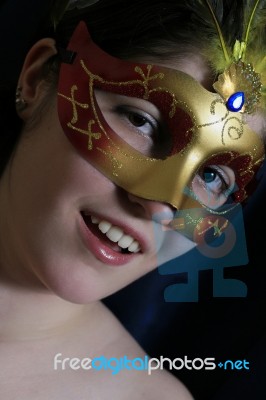 The Beautiful Young Girl In A Mask Stock Photo