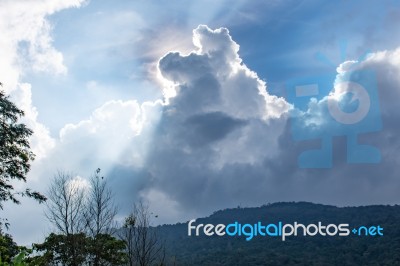 The Beauty Of The Sky When Light Hits The Clouds And Mountain Stock Photo