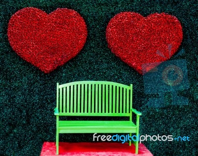 The Green Bench With Red Heart Background Stock Photo