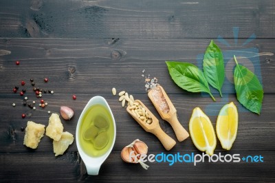 The Ingredients For Green Pesto Sauce On Dark Wooden Background Stock Photo