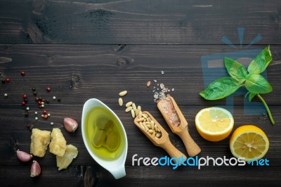 The Ingredients For Green Pesto Sauce On Dark Wooden Background Stock Photo