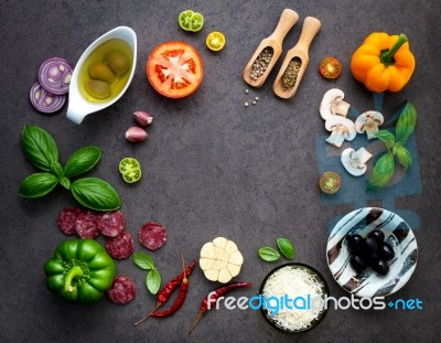 The Ingredients For Homemade Pizza On Dark Stone Background Stock Photo