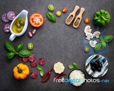 The Ingredients For Homemade Pizza On Dark Stone Background Stock Photo