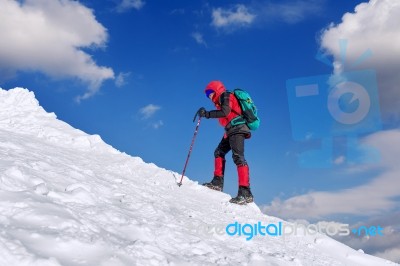 The Man In The Winter Journey With A Backpack On The Background Of Mountains Stock Photo