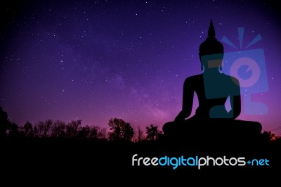 The Milky Way And Silhouette Of Buddha Statue Stock Photo