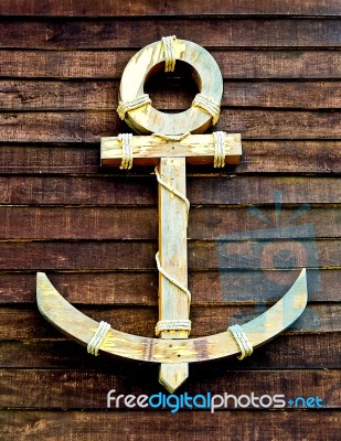 The Old Wooden Anchor On Wood Wall Background Stock Photo