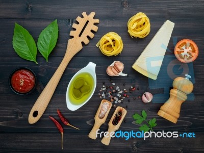 The  Pasta On Black Wooden Background. Yellow Italian Pasta With… Stock Photo
