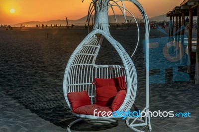The Swing On The Beach In The Sunset Stock Photo