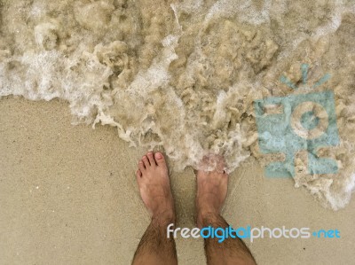 The Traveler Stand On The Sand Beach With Sea Wave Stock Photo