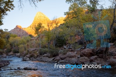 The Watchman Towers Over The Virgin River Stock Photo