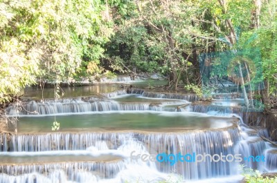 The Water Flowing Over Rocks And Trees Down A Waterfall At Huay Mae Khamin Waterfall National Park ,kanchana Buri In Thailand Stock Photo