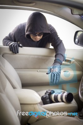 Thief Stealing Camera From Car Stock Photo
