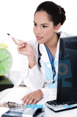 Thinking Doctor With Her Pen Stock Photo Thinking Doctor With Her Pen Stock Photo